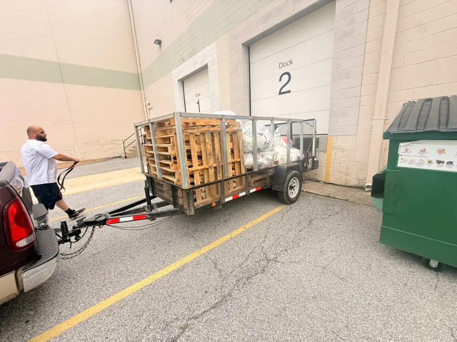 DumpGo crew unloading pallets and bags at a loading dock