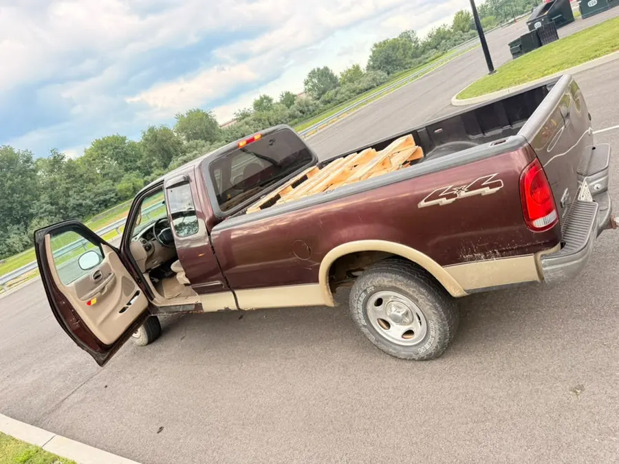 DumpGo pickup truck loaded with wood pallets